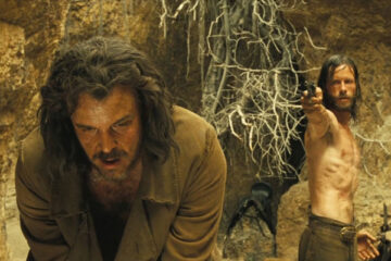 The Proposition 2005 Movie Scene Guy Pearce as Charlie holding a gun pointed at his brother, Danny Huston as Arthur