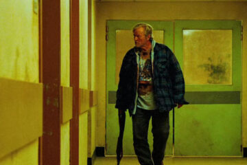 Hobo With A Shotgun 2011 Movie Scene Rutger Hauer as Hobo walking through the hospital holding a shotgun