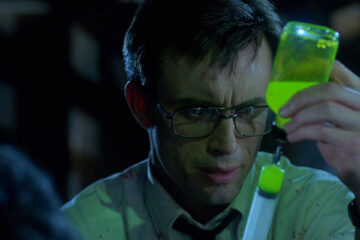 Re-Animator 1985 Movie Scene Jeffrey Combs as Herbert West drawing some of his glowing green serum into the syringe