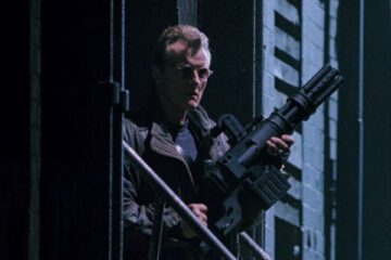 Split Second 1992 Movie Scene Rutger Hauer as Harley Stone holding a huge six-barrel gun
