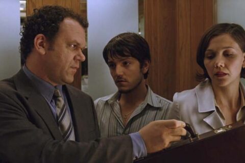 Criminal 2004 Movie Scene John C. Reilly as Richard Gaddis handing a briefcase full of cash to Maggie Gyllenhaal as Valerie with Diego Luna as Rodrigo looking at him