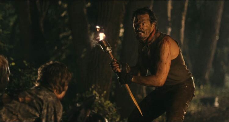 Stake Land 2010 Movie Scene Nick Damici as Mister holding huge wooden stake as the vampires start attacking him