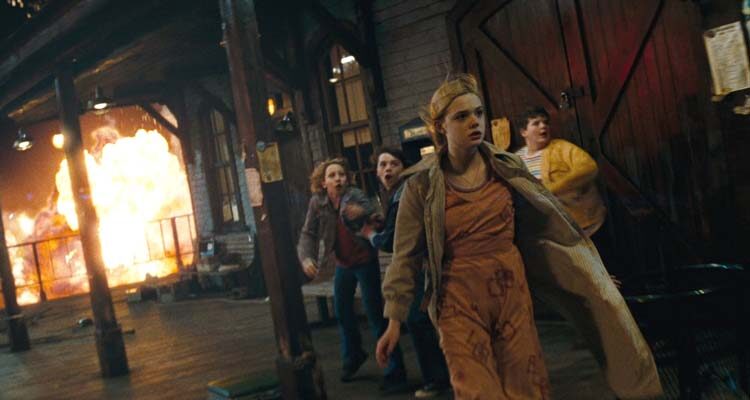 Super 8 Movie 2011 Scene Elle Fanning as Alice Dainard with the rest of the kids standing at the train station with the explosions in the background