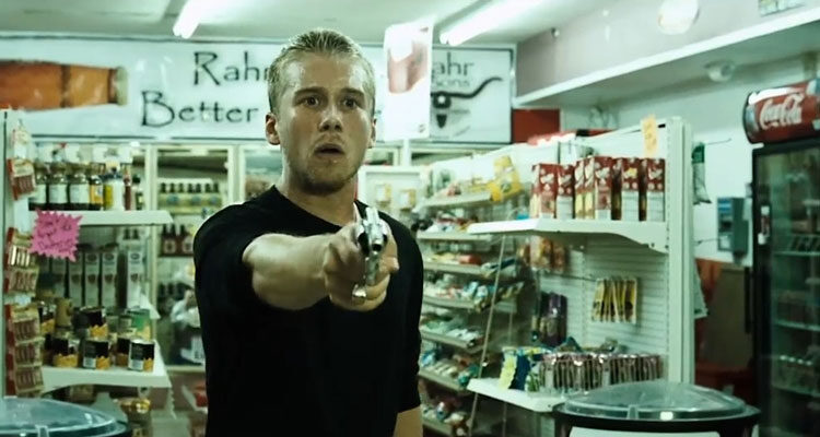 Brotherhood 2010 Movie Scene Lou Taylor Pucci as Kevin holding a gun while he's robbing a convenience store as part of a fraternity initiation