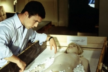 Love Object 2003 Movie Desmond Harrington as Kenneth Winslow looking at the newly arrived sex toy in a form of a life-like woman with blond hair