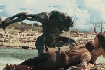 Cowboys & Aliens 2011 Movie Scene An alien creature attacking Daniel Craig as Jake and Olivia Wilde as Ella by the river