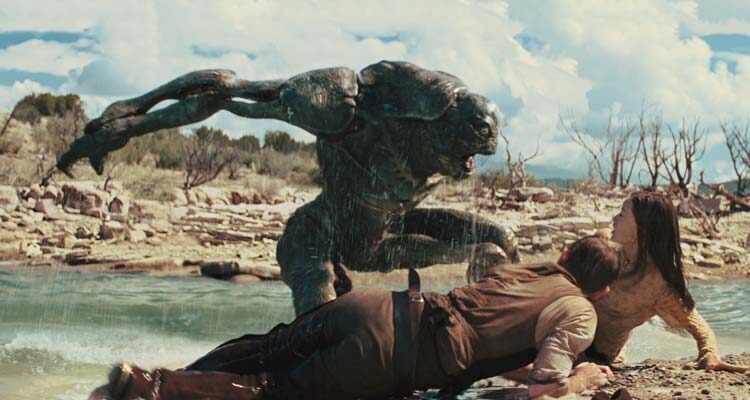 Cowboys & Aliens 2011 Movie Scene An alien creature attacking Daniel Craig as Jake and Olivia Wilde as Ella by the river