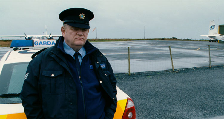 The Guard 2011 Movie Scene Brendan Gleeson as Gerry Boyle standing next to his police car