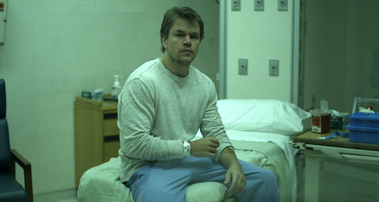 Contagion 2011 Movie Scene Matt Damon as Mitch Emhoff sitting in a hospital bed isolated after he contracted the virus