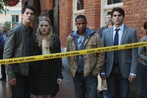 Final Destination 5 2011 Movie Scene Nicholas D'Agosto as Sam, Emma Bell as Molly, Arlen Escarpeta as Nathan and Miles Fisher as Peter Friedkin standing behind the police tape after another accident