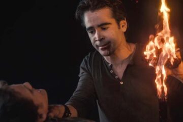Fright Night 2011 Movie Scene Colin Farrell as Jerry the vampire holding a burning cross in his hand