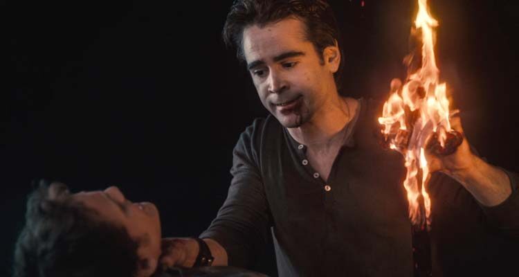 Fright Night 2011 Movie Scene Colin Farrell as Jerry the vampire holding a burning cross in his hand