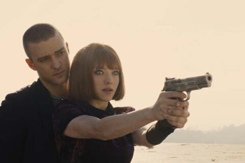 In Time 2011 Movie Scene Justin Timberlake as Will Salas teaching Amanda Seyfried as Sylvia Weis how to use a gun