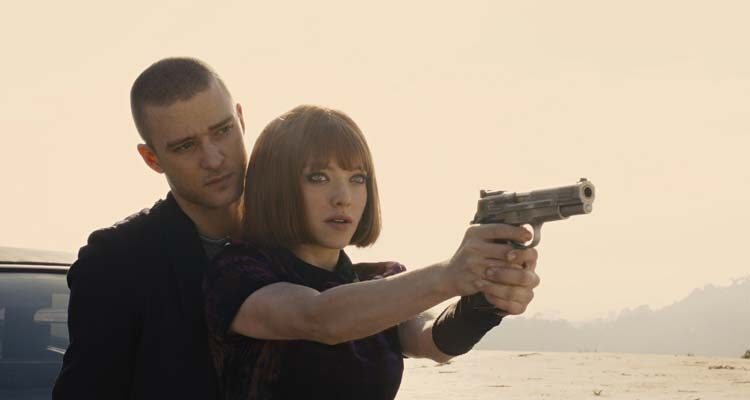 In Time 2011 Movie Scene Justin Timberlake as Will Salas teaching Amanda Seyfried as Sylvia Weis how to use a gun