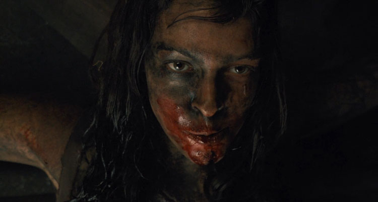 The Woman 2011 Movie Scene Pollyanna McIntosh as the feral woman chewing the finger of her captor