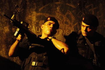 Tropa de Elite AKA Elite Squad 2007 Movie Scene Wagner Moura as Nascimento with one of his soldiers during a raid