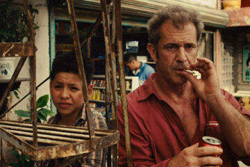Get The Gringo 2012 Movie Scene Mel Gibson as Driver smoking a cigarette and drinking coke inside a prison