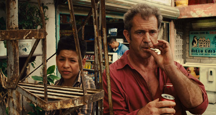 Get The Gringo 2012 Movie Scene Mel Gibson as Driver smoking a cigarette and drinking coke inside a prison