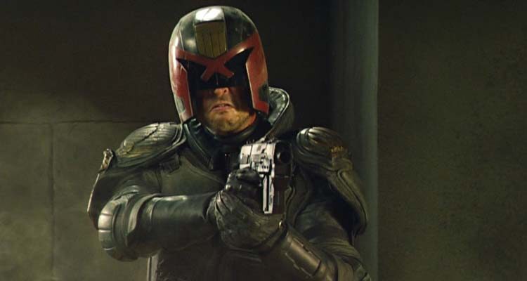 Dredd 2012 Movie Scene Karl Urban as Judge Dredd holding his gun