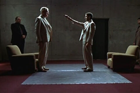 Intacto 2001 Movie Scene Leonardo Sbaraglia as Tomás holding a gun pointed at Max von Sydow as Samuel's head