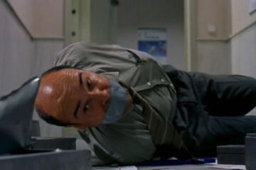 La Caja 507 2002 Movie Antonio Resines as Modesto Pardo laying on the floor of the bank all tied up