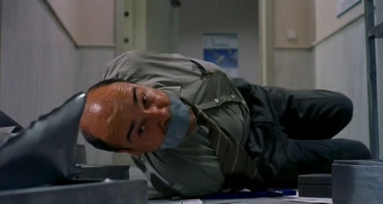 La Caja 507 2002 Movie Antonio Resines as Modesto Pardo laying on the floor of the bank all tied up