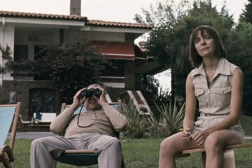 Timecrimes 2007 Movie Scene Karra Elejalde as Héctor watching his neighbors through his binoculars with Candela Fernández as Clara