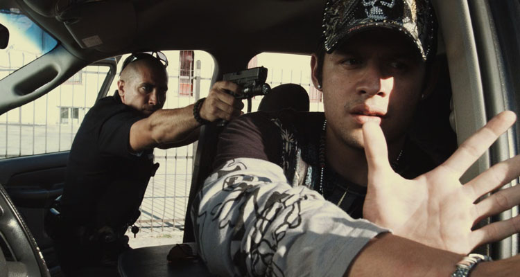 End of Watch 2012 Movie Scene Jake Gyllenhaal as Brian Taylor holding a gun to a cartel member's head after a routine stop