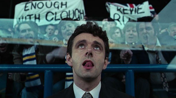 The Damned United 2009 Movie Scene Michael Sheen as Brian Clough at a game with banners behind asking for him to leave