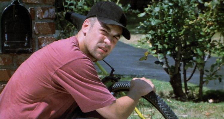 King of the Ants 2003 Movie Chris McKenna as Sean Crawley pretending to be fixing his bike across the accountant's house