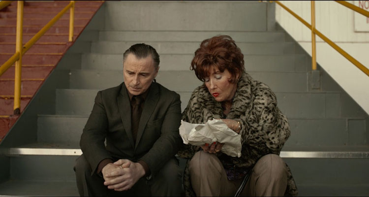 The Legend of Barney Thomson 2015 Movie Scene Robert Carlyle as Barney Thomson and Emma Thompson as Cemolina eating fish and chips at the dog racetrack