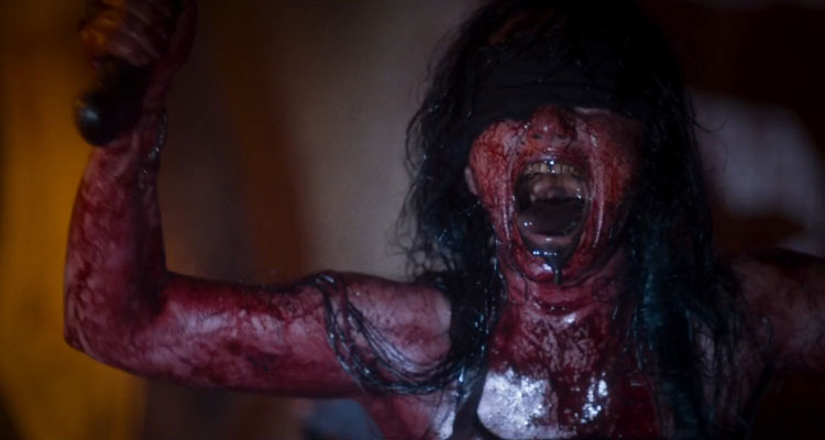 Baskin 2015 Movie Scene Fulya Peker as Mother Butcher all covered in blood, screaming and waving a machete