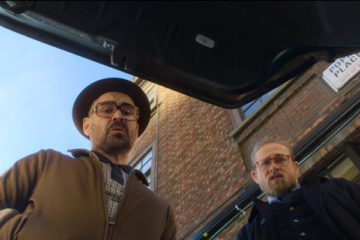 The Gentlemen 2019 Movie Review Charlie Hunnam as Ray and Colin Farrell as Coach looking at trunk of a car