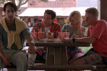 True Romance 1993 Movie Christian Slater, Patricia Arquette, Michael Rapaport and Bronson Pinchot seating at a table after a roller-coaster ride scene