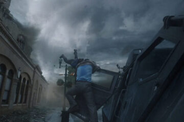 Into The Storm 2014 Movie Richard Armitage as Gary trying to save Sarah Wayne Callies as Allison as she's barely hanging on to a door of a tornado vehicle while being pulled towards tornado