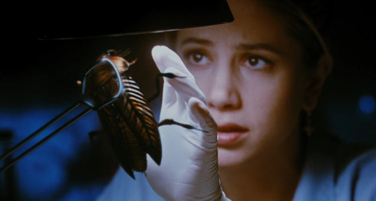 The Mimic 1997 Movie Mira Sorvino holding a giant cockroach