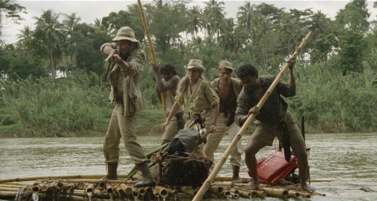 The Mountain of the Cannibal God 1978 Movie Ursula Andress, Stacy Keach and the rest of the crew on a raft trying to shoot a crocodile that just attacked them