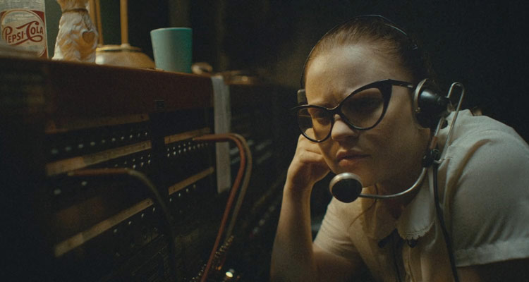 The Vast of the Night 2019 Movie Sierra McCormick as Fay Crocker in switchboard room listening to strange signal coming from the telephone line