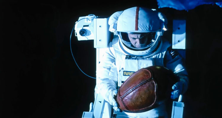 Moontrap 1989 Movie Walter Koenig in space suit holding a strange object that resembles an egg that he just retrieved from a derelict ship