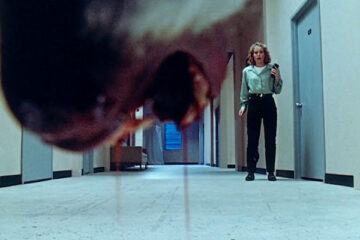 Shakma 1990 Movie Jaws of a killer baboon open dripping with blood as Amanda Wyss is standing in the hallway