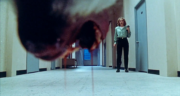 Shakma 1990 Movie Jaws of a killer baboon open dripping with blood as Amanda Wyss is standing in the hallway