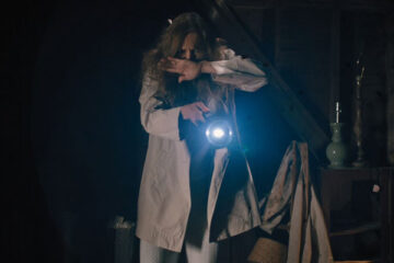 Hereditary 2018 Movie Toni Collette shining a flashlight in her attic