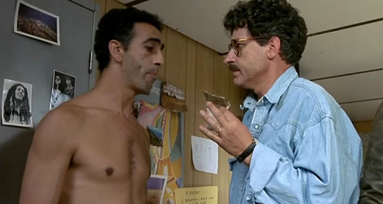 L627 1992 Movie Didier Bezace as Lulu holding a bag of powdery substance, most likely heroin, in front of a naked suspect
