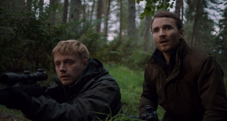 Calibre 2018 Movie Jack Lowden holding a sniper rifle and Martin McCann watching in horror