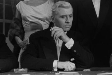 Bob Le Flambeur 1956 Movie Roger Duchesne as Robert 'Bob' Montagné gambling in a casino and smoking a cigarette