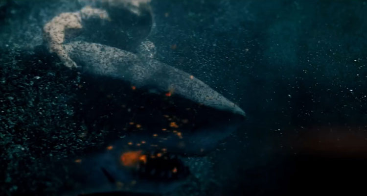 Great White 2021 Movie News Scene A shark swimming with a flare in its mouth as a person is holding on to it