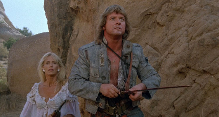 Hell Comes to Frogtown 1988 Movie Scene Sandahl Bergman and Roddy Piper holding a bloody sword fighting frog mutants