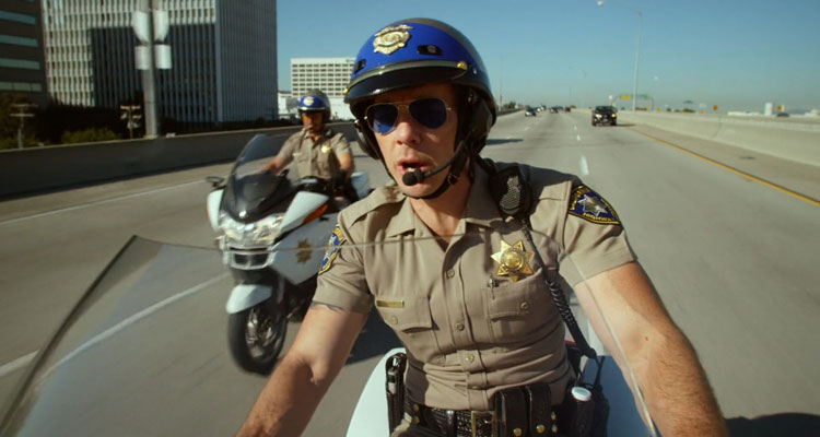 CHIPS 2017 Movie Scene Dax Shepard as Jon and Michael Peña as Ponch riding motorbikes down the highway during a chase