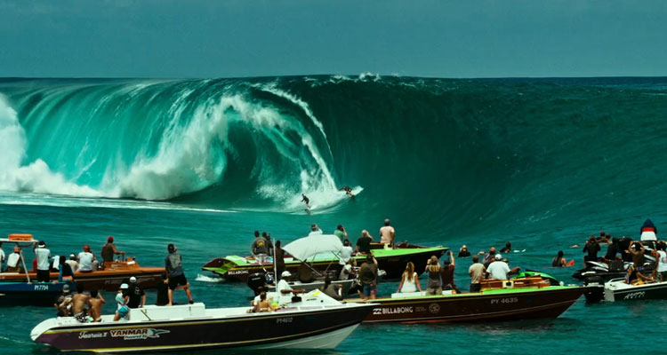 Point Break 2015 Movie Scene Luke Bracey as Utah and Edgar Ramírez as Bodhi riding a giant wave with dozens of onlookers watching from their boats