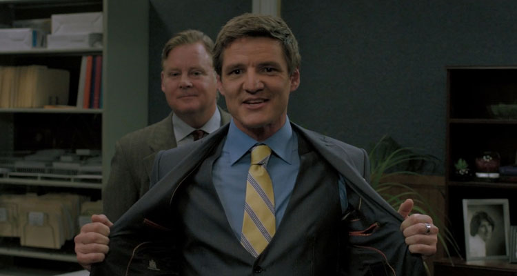 Bloodsucking Bastards 2015 Movie Scene Pedro Pascal as Max in a suit smiling with Joel Murray as Ted behind him